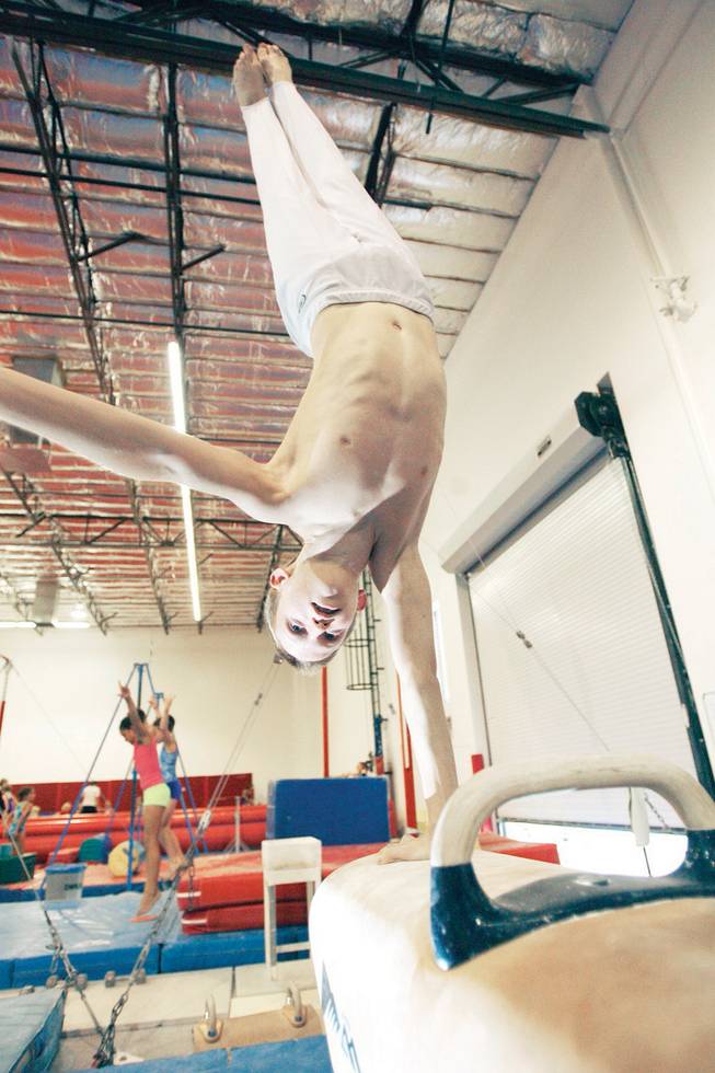 Gymnast Jeff Frantom, 12, balances on the pommel horse while training at the Gymcats, an Olympics style gymnastics-training center.
