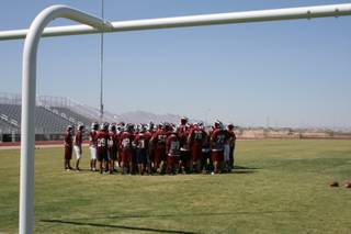 The Desert Oasis football team gathers on its new football field Thursday for its last practice before Friday's opening game.