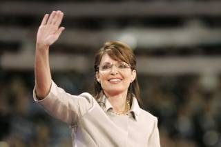 John McCain's vice presidential pick Sarah Palin waves as she takes the stage at the Republican National Convention on Wednesday night.