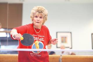 Sun City resident Carlene LeFevre returns the ball down the line to Mary Lou Burbine during the Tuesday night ping pong club matches Aug. 19 at Desert Willow Community Center.