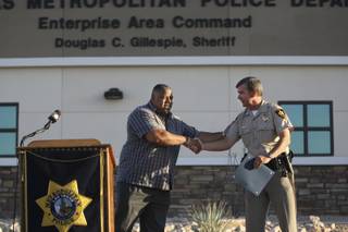 On behalf of Sen. Harry Reid, Charvez Foger, left, congratulates Sheriff Douglas Gillespie on the completion of the Enterprise Area Command Center and presents a proclamation certificate to the Las Vegas Metropolitan Police Department during a grand opening ceremony Tuesday.  The newest substation is located at 6975 West Windmill Lane off of South Rainbow.