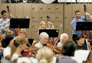 Members of  the Henderson Symphony Orchestra play during a rehearsal at Greenspun Junior High School