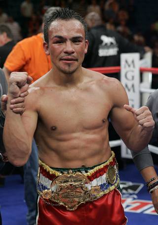 Juan Manuel Marquez of Mexico poses after his 11th-round technical knock out over Joel Casamayor of Cuba at the MGM Grand Garden Arena in Las Vegas on Saturday night. Marquez, fighting for the first time at the 135-pound weight class, claimed the Ring Magazine Lightweight crown with the victory.