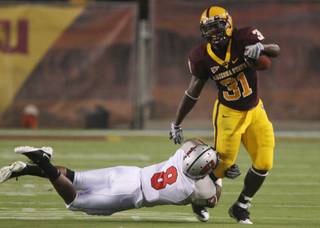 UNLV defensive back Daryl Forte (8) tackles Arizona State running back Dimitri Nance (31) in the first quarter.