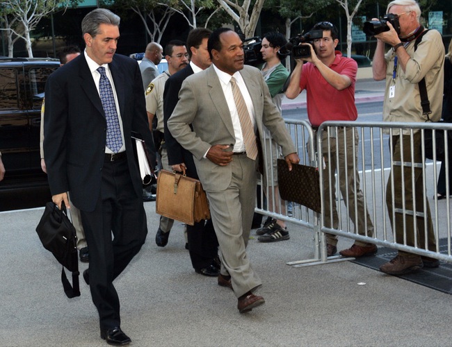 O.J. Simpson arrives Monday for the first day of his trial at the Clark County Regional Justice Center. Attorney Gabriel Grasso is at left. 