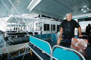 Boulder City resident Bob Kirk stands in his 2,300-square-foot houseboat. The boat is docked at the Las Vegas Boat Harbor.
