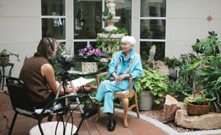 Ada Garbo, right, shares her story with Cara Fay, a volunteer filmmaker making a documentary about residents at The Homestead in Boulder City.