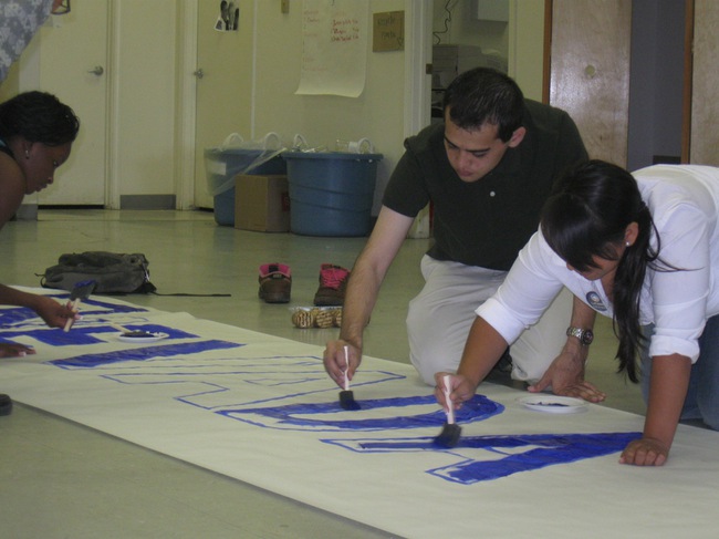 Campaign for Change staff members, Jeremy Cohen, left and Loida Tapia help fill in the letters to a sign that will be used at Democratic Presidential nominee Barack Obama's speech at Cashman Field Wednesday.