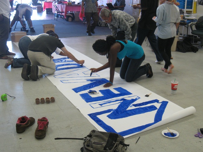 Staff members and volunteers for the Obama Campaign for Change came together Tuesday to prepare for the senator's arrival and speech Wednesday at Cashman Field.  