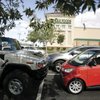 The Smart Fortwo Passion Coupe faces off with a Hummer H2 Thursday in the parking lot of Whole Foods at The District in Henderson. The Towbin dealership on Sahara Avenue, which until last week sold Hummers, has gone to the opposite extreme, carrying the two-seat Smart cars and, soon, scooters (as well as Rolls Royces and Bentleys).
