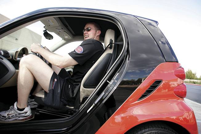Jack Schenk, a 6-foot-8-inch trainer at 24 Hour Fitness, tries out the German-made Smart Fortwo Passion Coupe. He had enough headroom, but the steering wheel landed low in his lap. His main objection, though, was to the car's color -- orange.