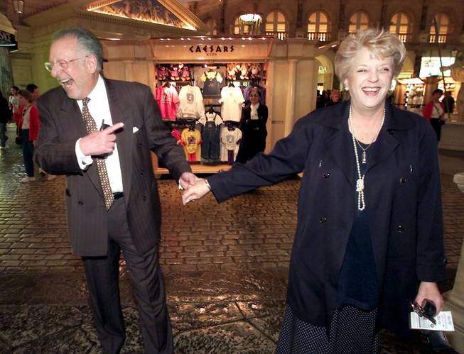 Las Vegas Mayor Oscar Goodman and his wife, Carolyn, share a light moment in 2002 at the Forum Shops at Caesars Palace. Goodman has raised the possibility that his wife might run for his post when term limits end his mayorship in 2011. She hasn't revealed her intentions.