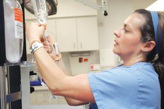 Nicole Evans sets up an IV during a demonstration on Sept. 18 at St. Rose Dominican Hospital -- Siena Campus. The trauma center at the hospital has completed verification as a Level 3 trauma center.  
