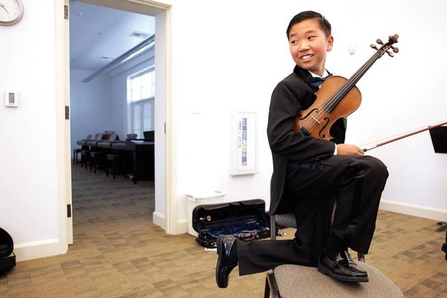 Nevada School of the Arts violin student Michael Kwok, 12, pauses during rehearsal Monday in one of the new practice rooms at the Fifth Street School in downtown Las Vegas.
