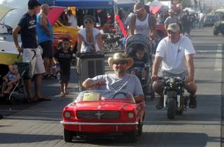 Roger Nitti, now quite grown up, drives the 1965 Ford Mustang Jr. go-kart his father bought him when he was 9 years old up Water Street during the Super Run Car Show on Friday.
