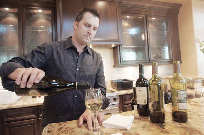 In a special sneak preview of business that will be located in Tivoli Village at Queensridge, Ryan Vance, a founder of Townsend Wine Bar, gives out samples of his wine on Sept. 22.  