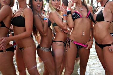 Models hired by the hotel for a magazine photographer stand in the shallow water of the Rehab pool.  