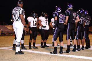 Durango and Clark captains meet for the coin toss at the beginning of Friday night's game at Durango High School. 