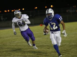 Basic wide receiver Justin Burdno (12) runs the ball during Friday's home game against Silverado.