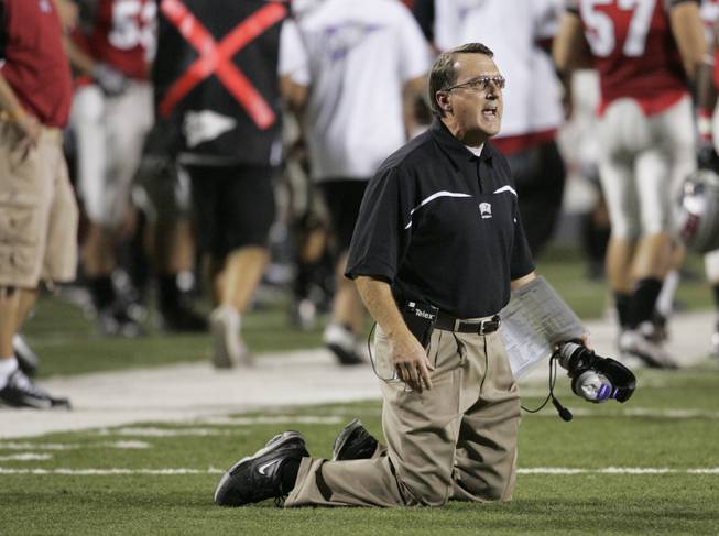 UNLV coach Mike Sanford argues with a referee, saying a UNR player was on his knees during the first half of last season's rivalry matchup at Sam Boyd Stadium. The Wolf Pack were victorious in 2008, 49-27, and Sanford this Saturday will look for his first win against UNR in five tries.
