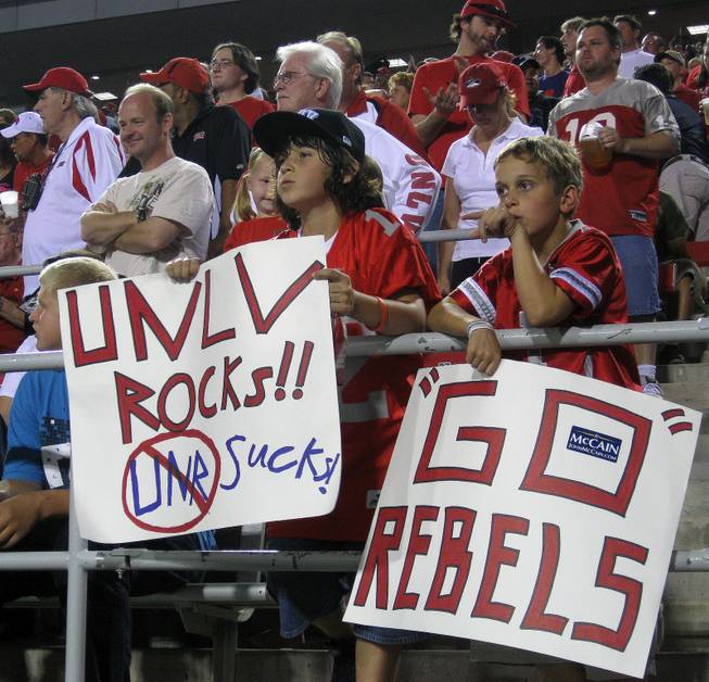 Young Rebels fans Gage Guerin (left), 10, and friend Matthew Parton, 8, cheer on the Rebels during the first half of their loss to UNR Saturday at Sam Boyd Stadium.