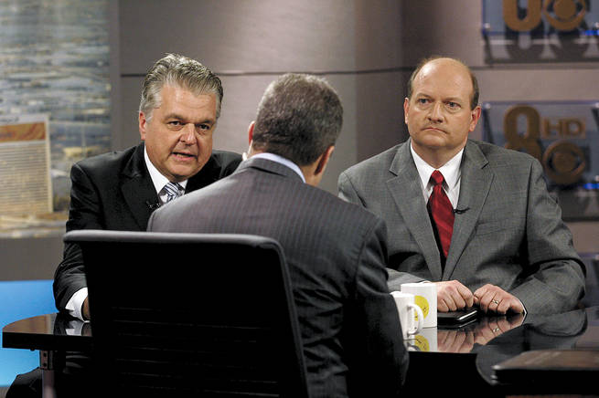 Steve Sisolak, left, and Brian Scroggins talk to moderator Jon Ralston during a taping of "Face to Face With Jon Ralston" on Friday.