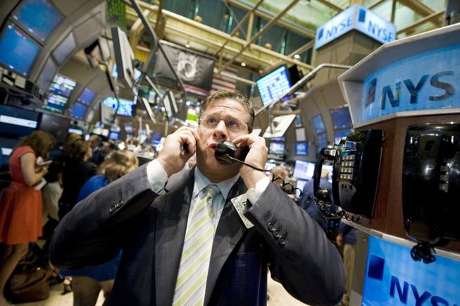 Trader Steve Ferretti uses two phones as he works on the floor of the New York Stock Exchange, Tuesday Sept. 30, 2008. Stocks staged a partial rebound early Tuesday after their biggest sell-off in years, though financial markets remained troubled a day after lawmakers rejected a $700 billion rescue plan for the financial sector.