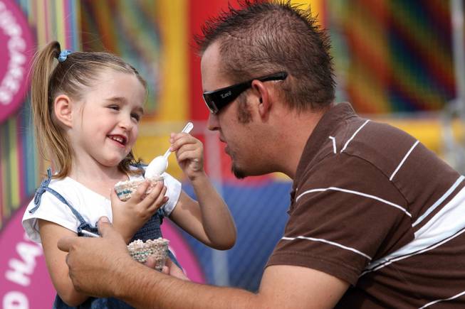 Jared Evans listens to his daughter share funny stories while eating Dippin' Dots at The Bite of Las Vegas 2007.