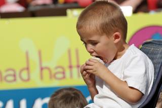 Taylor Evans, 3, digs into a cupcake from Mad Hatter Cupcakes' booth at the Bite of Las Vegas 2007.