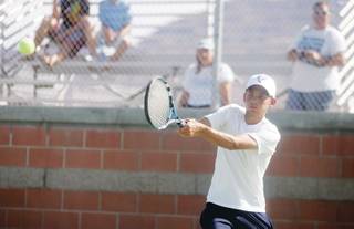 Foothill's Dylan Ellis sends the ball flying back to his opponent during a tennis match against Boulder City at Foothill High School on Sept. 29. 