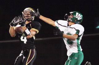 Faith Lutheran wide receiver Don Pearson completes a long pass during Friday's home football game against Virgin Valley.