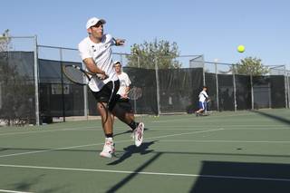 Palo Verde's Josh Levinson hits cross court in mid-air while playing Friday with doubles partner Dillon Berkabile against Bishop Gorman's Alec Thomas and Kyle Del Rosario.