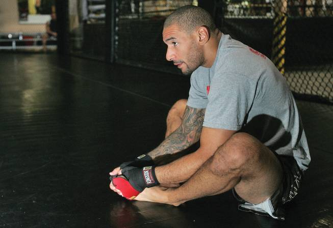 Jay Hieron, a mixed martial artist, stretches out before beginning his training at X-Treme Couture Gym on Oct. 3. Hieron is getting ready for Night of Combat 2, a fight card at the Thomas and Mack Center.  