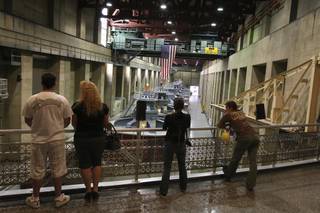 Water conservationists, from left, Doug Myers, Tammy Myers, Cat Sawai and Tui Anderson observe the seven-story-high hydroelectric generators while touring the power plant at the Hoover Dam with the WaterSmart Innovations Conference on Friday.