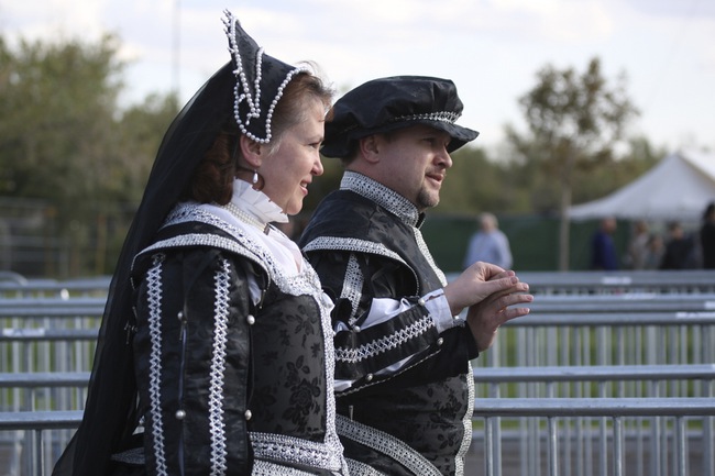 Arriving fashionably late, Ted Sell escorts his wife, Sandy, to the ticket booth of the Act of Chivalry Renaissance Festival on Saturday.