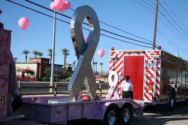 Las Vegas firefighter Tawni Petropoulos looks at the signatures on the pink fire truck Wednesday morning in North Las Vegas. 