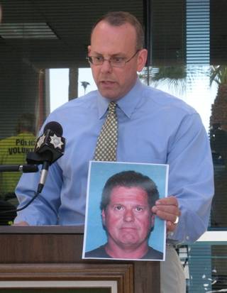 LVMPD Capt. Vincent Cannito holds up a photo of the number one person of interest, Clemens Fred Tinnemeyer, in the case to find Cole Puffinburger at a press conference today.
