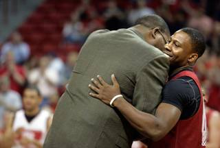 UNLV player Wink Adams, right, hugs Sidney Green, a former UNLV player and the second all-time leader in points scored, during a ceremony at the UNLV basketball team's first practice at the Thomas & Mack Center on Friday.