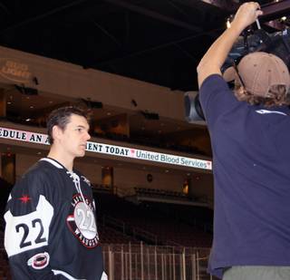 Las Vegas Wranglers center Chris Neiszner prepares for a television interview during the Wranglers' media day at Orleans Arena on Monday.