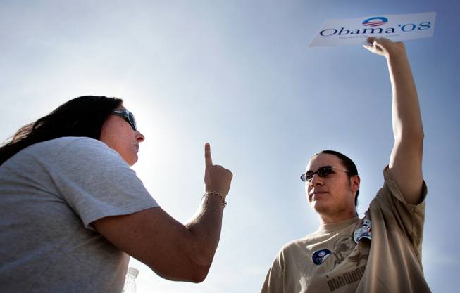 Lisa Freetly, left, a John McCain supporter from Las Vegas, asks Barack Obama supporter Nicholai Hermosillo of Henderson to name some of Obama's policies while confronting him outside the Sarah Palin rally at the Henderson Pavilion in Henderson Tuesday.