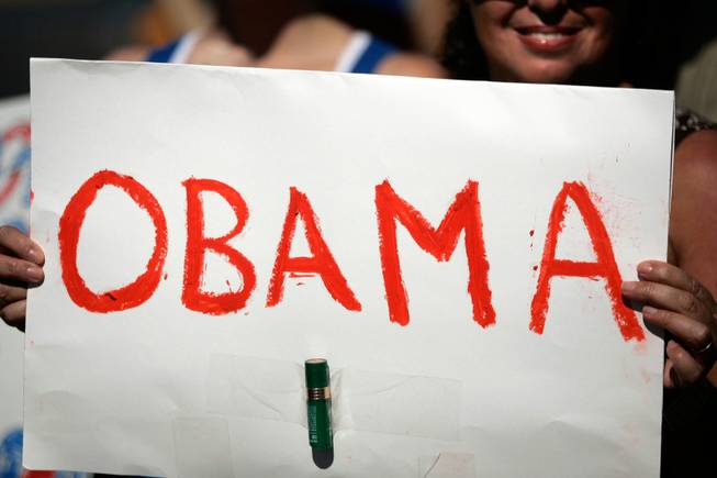 Carole Fougere, a Barack Obama supporter from Henderson, holds a sign written in lipstick while demonstrating on the corner of Green Valley Parkway and Paseo Verde Parkway outside the Sarah Palin rally at the Henderson Pavilion in Henderson Tuesday.