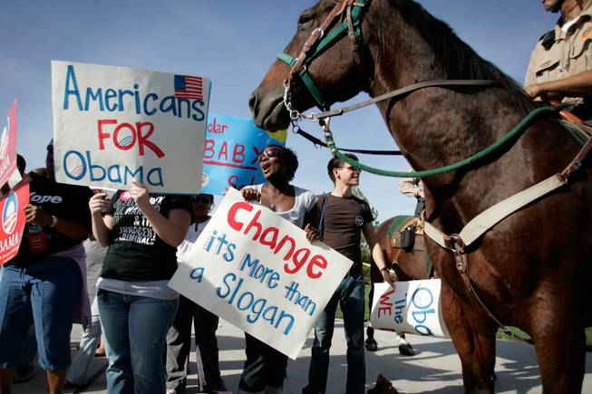 Barack Obama supporter demonstrate outside the Sarah Palin rally as Metro mounted police officers keep the peace at the Henderson Pavilion in Henderson Tuesday.