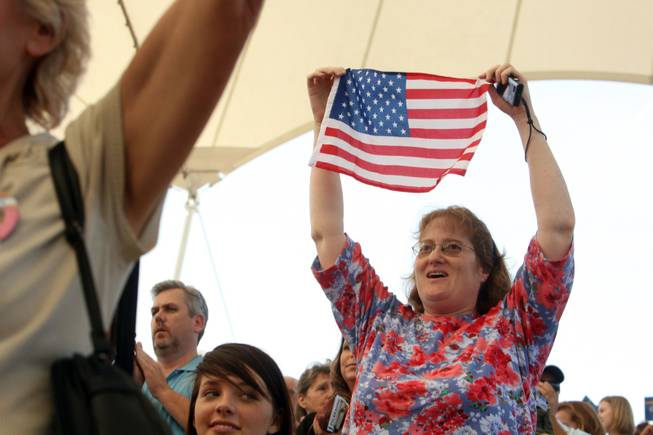 Patti Schmidgall holds up an American flag as the National Anthem is performed during a rally with Republican vice presidential nominee and Alaska Governor Sarah Palin in Henderson, Nev., Tuesday, October 21, 2008. 