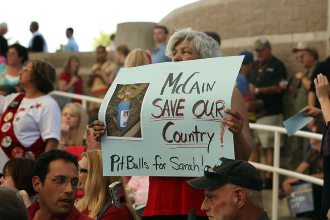 Supporter Suzanne Thomas of Las Vegas holds up a sign with a photo of her brothers pit bull as she waits for Republican vice presidential nominee Alaska Governor Sarah Palin at a rally in Henderson, Nev., Tuesday, Oct. 21, 2008. 