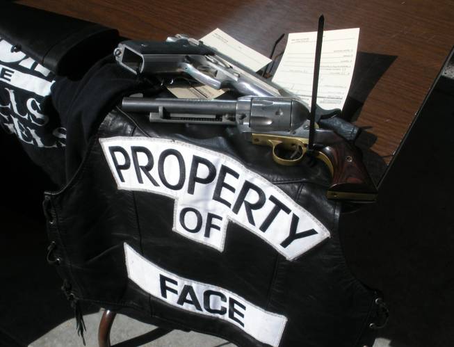 Mongols pistol and flag (black leather vest with gang insignia) confiscated by law enforcement Tuesday.