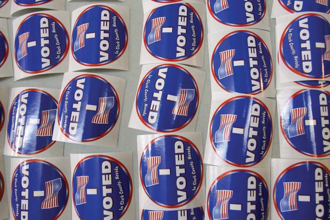Stickers lay ready to be given out during early voting at Galleria Mall on Monday.