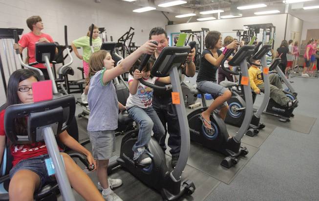 Students and their families exercise in the fitness room during Thurman Middle School's family fitness and dinner night on Oct. 16.
