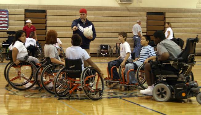 Bob Murray, assistant coach for the U.S. wheelchair rugby team, teaches kids the basic rules of wheelchair rugby. The team took home gold at the 2008 Beijing Paralympics.