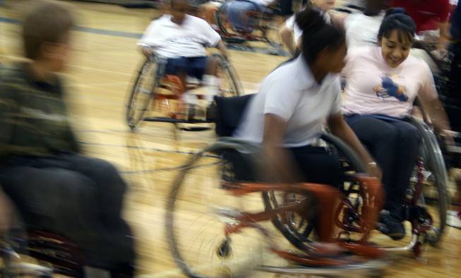 Cadwallader middle school student Cheyenne Leonard races another kid to the ball during an intense bout of wheelchair rugby.