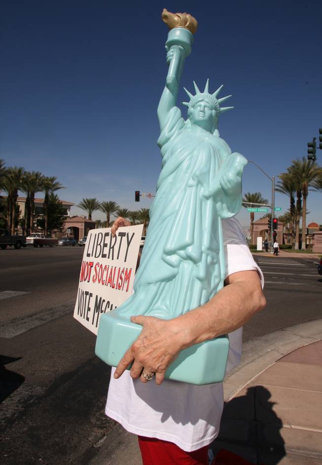 McCain-Palin supporter Jody Black, left, stands on the corner of Green Valley and Paseo Verde parkways as Ashley Hall, right, brings up a sign outside the Henderson Pavilion where Republican vice presidential candidate Sarah Palin will be speaking Tuesday, October 21, 2008. Black said she planned to bring "Miss Liberty" inside the rally but when was told she probably couldn't, she took up a spot on the corner. 